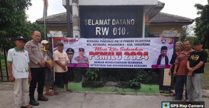 Babinkamtibmas Kel.kuta baru Aipda Agus melaksanakan pemasangan sepanduk pemilu damai 2024