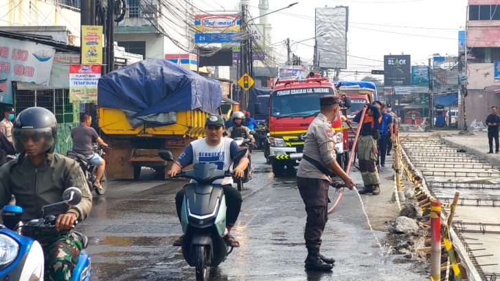 Polsek Pasar Kemis Siram Jalan, Kurangi Dampak Debu Abu Vulkanik Demi Keselamatan Pengendara